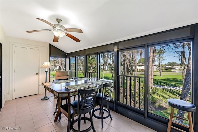 sunroom featuring ceiling fan, a healthy amount of sunlight, and vaulted ceiling