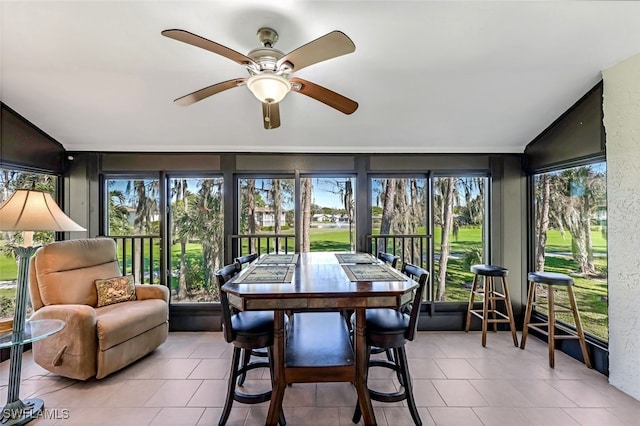 sunroom / solarium featuring ceiling fan