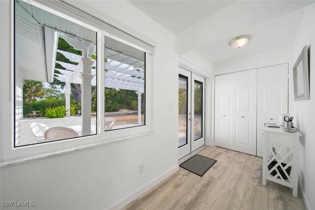 doorway to outside with french doors and light hardwood / wood-style floors