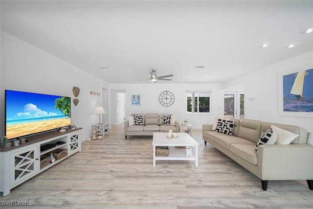 living room featuring light wood-type flooring and ceiling fan