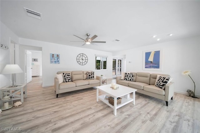 living room with light wood-type flooring and ceiling fan