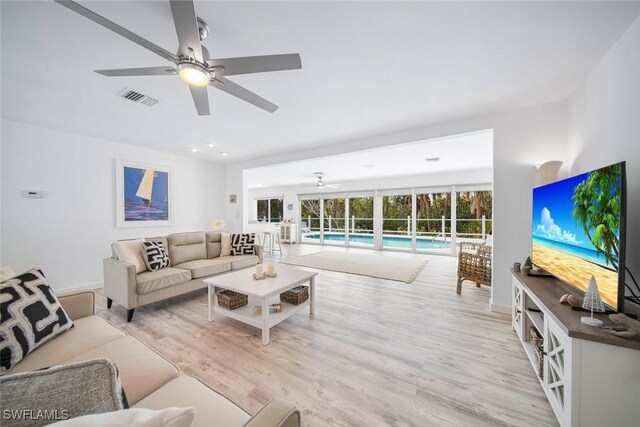 living room featuring light wood-type flooring and ceiling fan