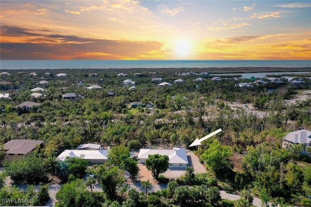 aerial view at dusk with a water view