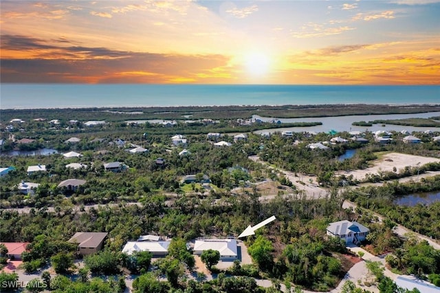 aerial view at dusk with a water view