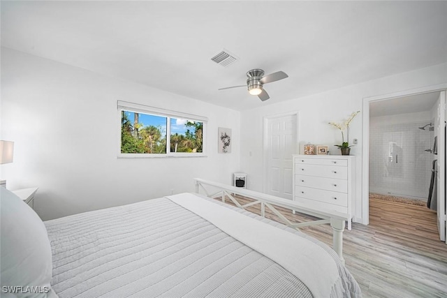 bedroom with ensuite bath, light hardwood / wood-style flooring, and ceiling fan