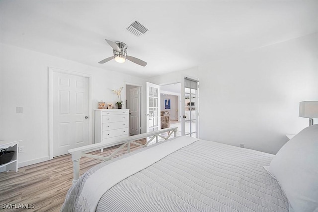 bedroom with french doors, light wood-type flooring, and ceiling fan