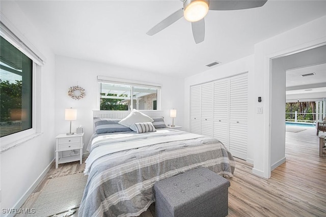 bedroom featuring ceiling fan, light wood-type flooring, and a closet