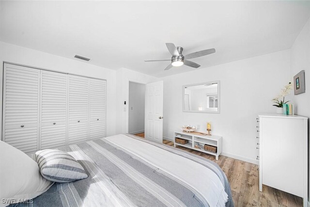 bedroom featuring light wood-type flooring, a closet, and ceiling fan