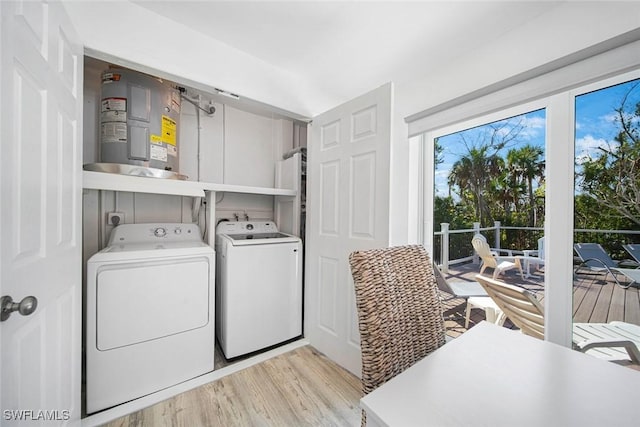 washroom with light hardwood / wood-style floors and washer and clothes dryer