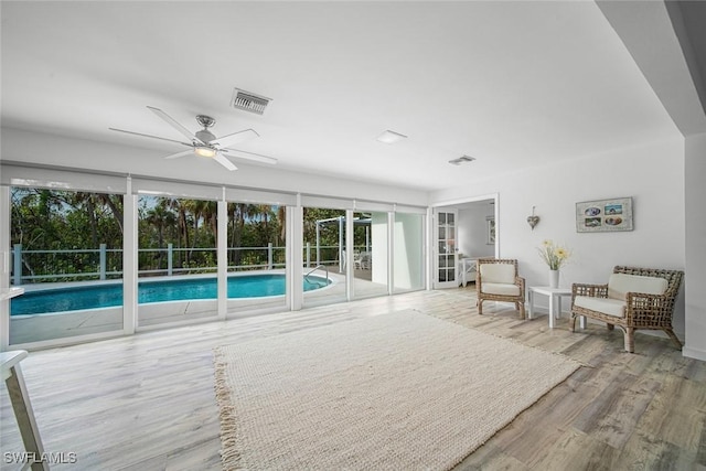 interior space with ceiling fan