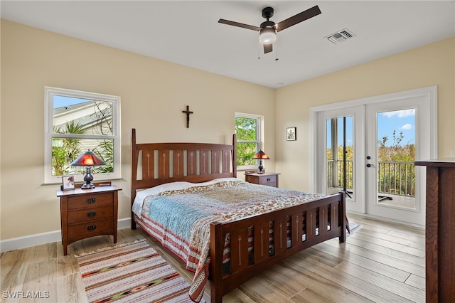 bedroom with access to outside, light hardwood / wood-style floors, multiple windows, and ceiling fan