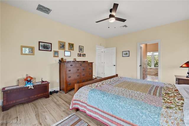 bedroom with connected bathroom, light hardwood / wood-style floors, and ceiling fan