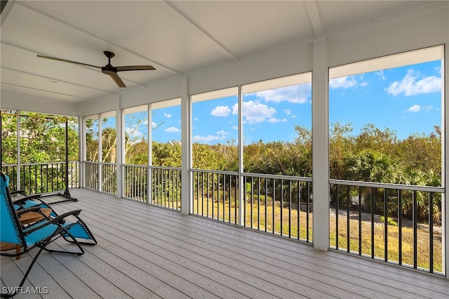 unfurnished sunroom featuring ceiling fan