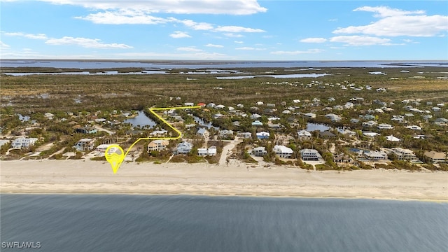 drone / aerial view featuring a water view and a view of the beach