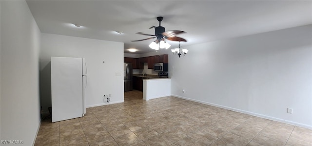 unfurnished living room featuring ceiling fan with notable chandelier