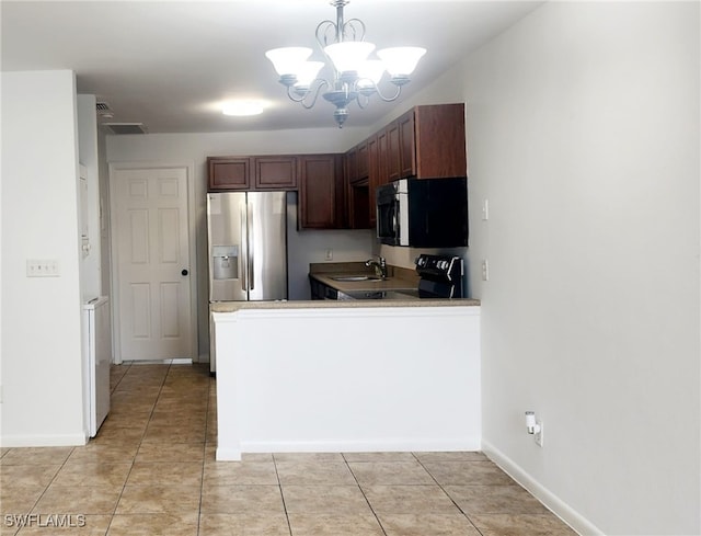 kitchen with kitchen peninsula, hanging light fixtures, appliances with stainless steel finishes, dark brown cabinetry, and a chandelier