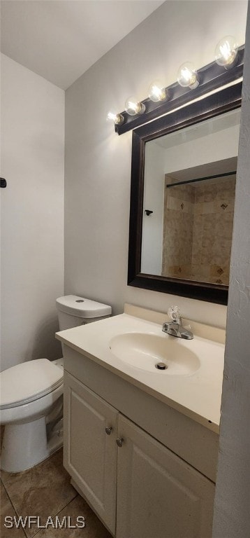 bathroom featuring tile patterned floors, vanity, and toilet