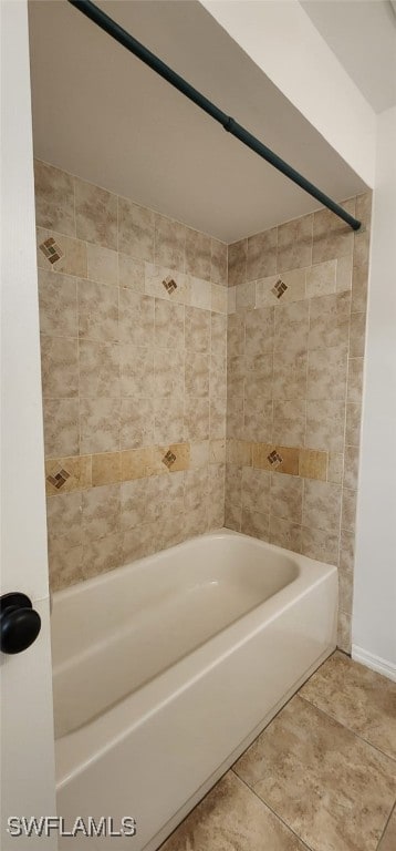 bathroom with tile patterned floors and tiled shower / bath