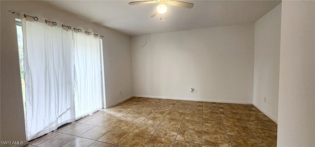 tiled spare room with plenty of natural light and ceiling fan