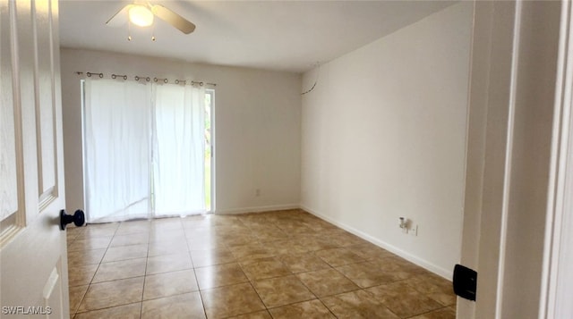 spare room featuring ceiling fan and light tile patterned floors