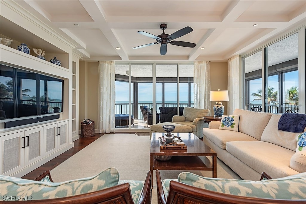 living room featuring hardwood / wood-style floors, ceiling fan, a healthy amount of sunlight, and coffered ceiling