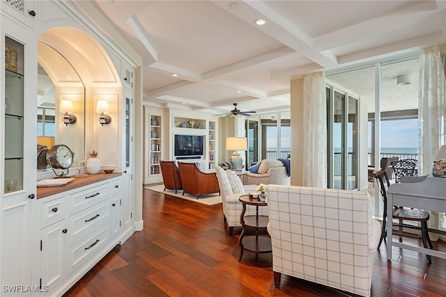 living room with beam ceiling, ceiling fan, dark wood-type flooring, and coffered ceiling