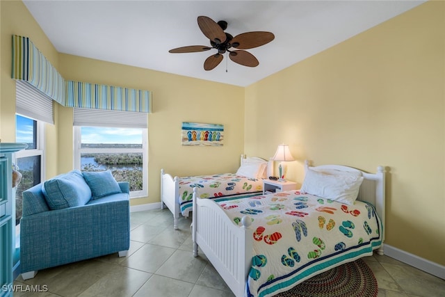 tiled bedroom featuring ceiling fan