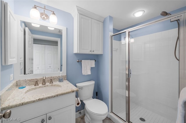 bathroom with vanity, toilet, and walk in shower