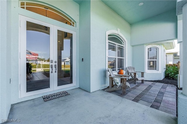 property entrance with a patio area and french doors