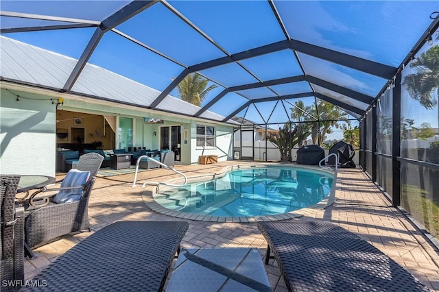 view of pool featuring an outdoor hangout area, a patio, ceiling fan, and glass enclosure