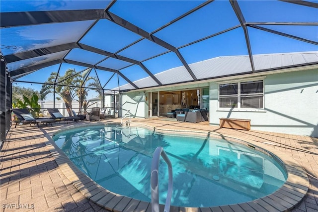 view of swimming pool with an outdoor hangout area, glass enclosure, and a patio area