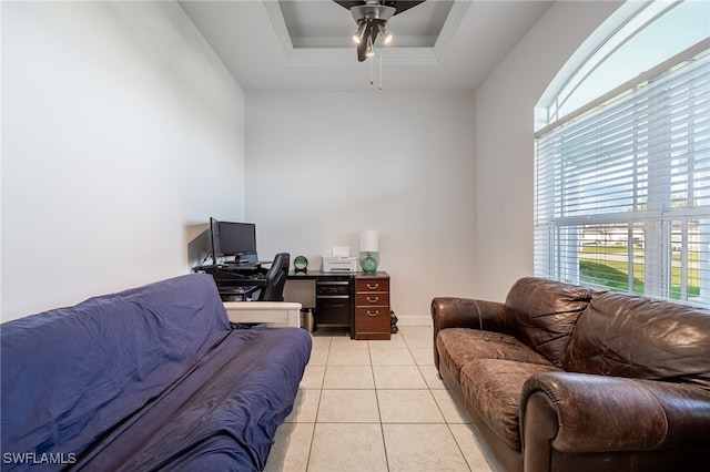 tiled office with ceiling fan and a tray ceiling