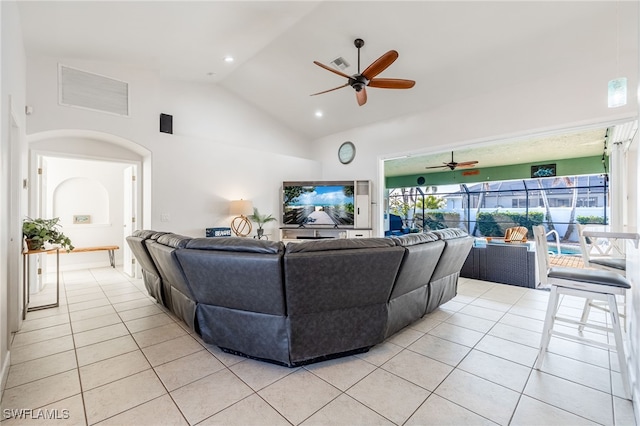 living room with light tile patterned floors, high vaulted ceiling, and ceiling fan