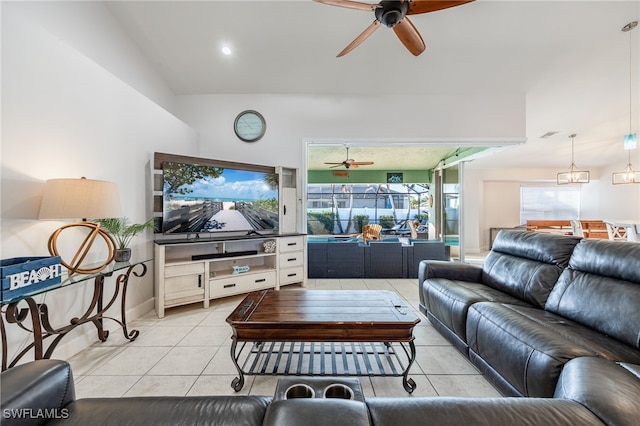 tiled living room featuring ceiling fan with notable chandelier