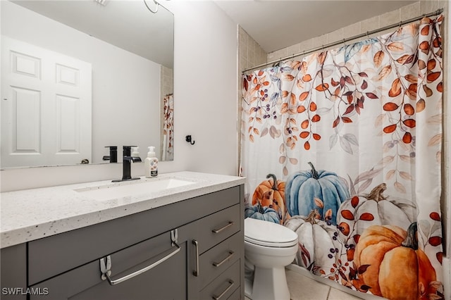 bathroom featuring tile patterned flooring, vanity, curtained shower, and toilet