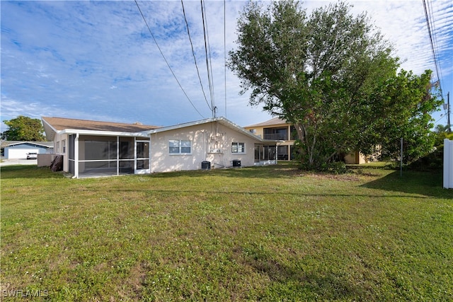 back of house featuring a yard, central AC, and a sunroom