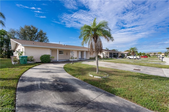 single story home featuring a front lawn