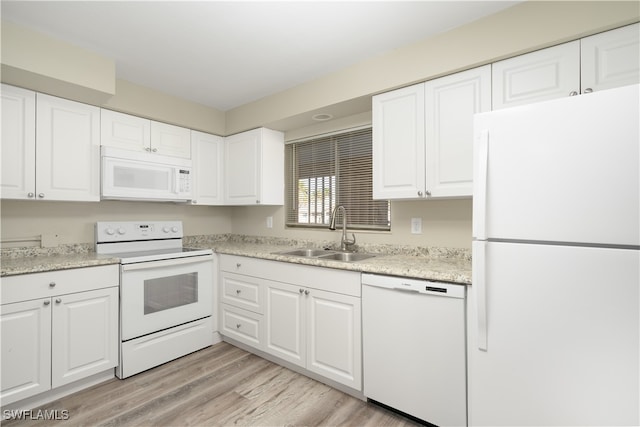 kitchen featuring light stone countertops, white appliances, sink, white cabinets, and light hardwood / wood-style floors