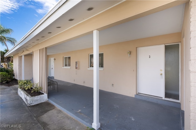 doorway to property with a patio area