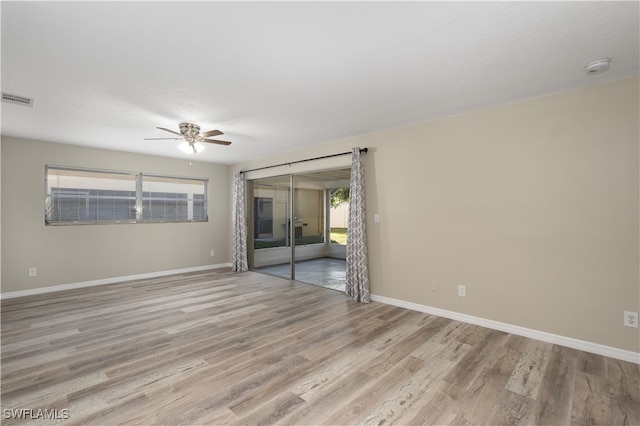 spare room featuring ceiling fan and light wood-type flooring