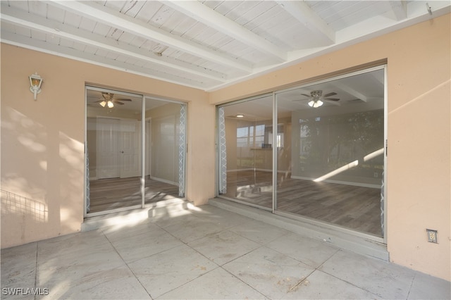 unfurnished sunroom with beamed ceiling