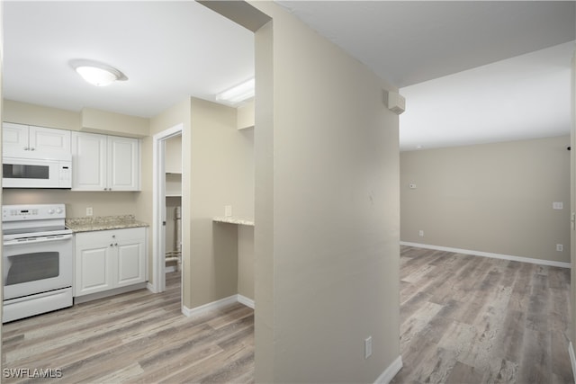 kitchen featuring light wood-type flooring, white appliances, white cabinetry, and light stone countertops