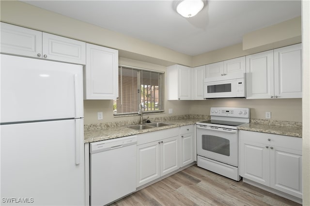 kitchen with white cabinets, white appliances, light hardwood / wood-style flooring, and sink