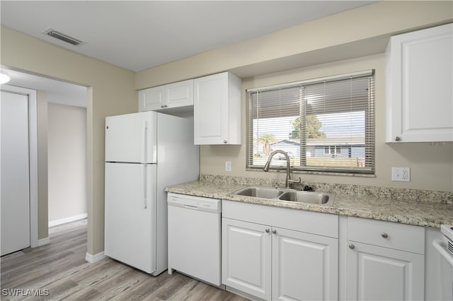 kitchen with white cabinets, light hardwood / wood-style floors, white appliances, and sink