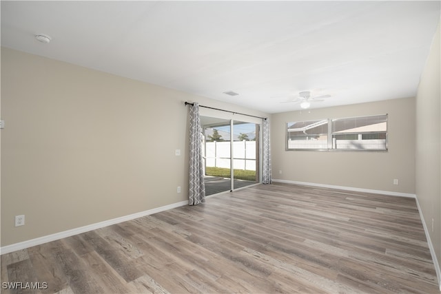 spare room featuring light hardwood / wood-style floors and ceiling fan