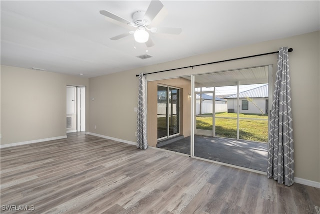 empty room featuring hardwood / wood-style floors and ceiling fan