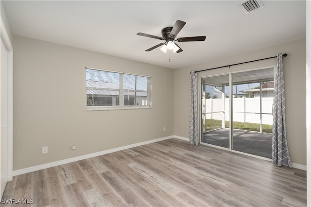 unfurnished room with a wealth of natural light, ceiling fan, and light hardwood / wood-style floors