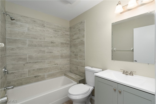 full bathroom with vanity, tiled shower / bath combo, and toilet