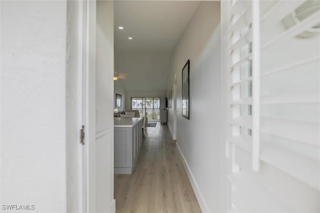 corridor with light hardwood / wood-style floors