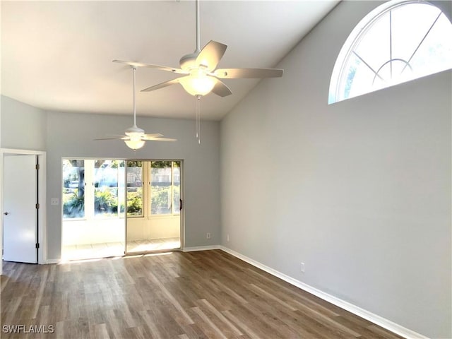 empty room with ceiling fan, wood-type flooring, and high vaulted ceiling